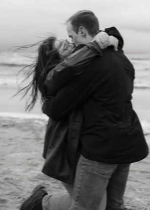 A very cute couple smooching.