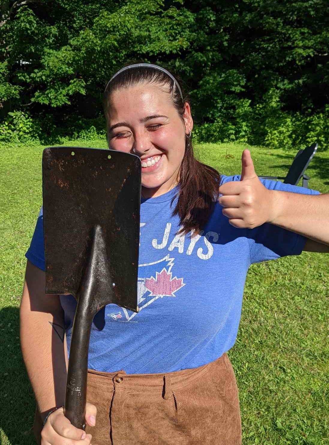 Very pretty woman with a clean, shiny shovel.