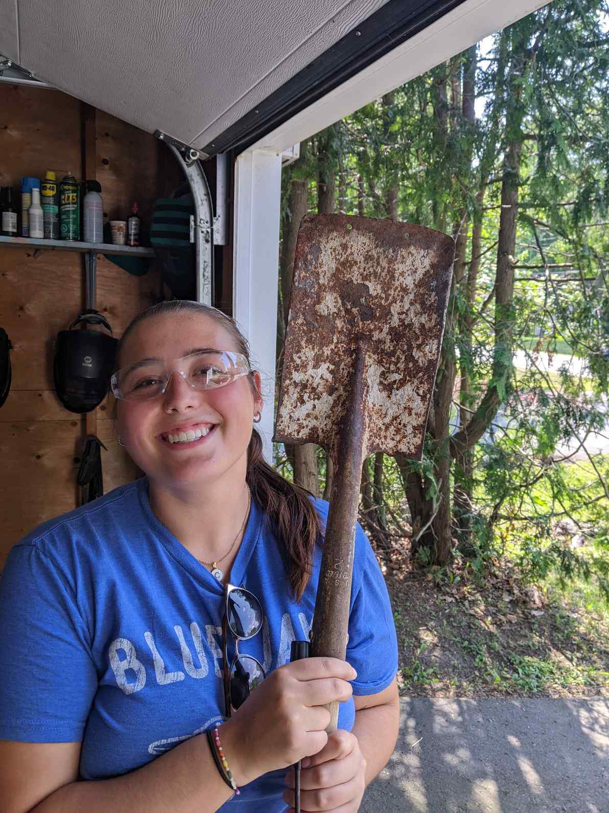 Very pretty woman with a dirty shovel.